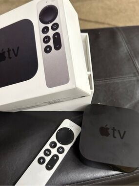 Apple TV set-top box with white Siri Remote missing cords